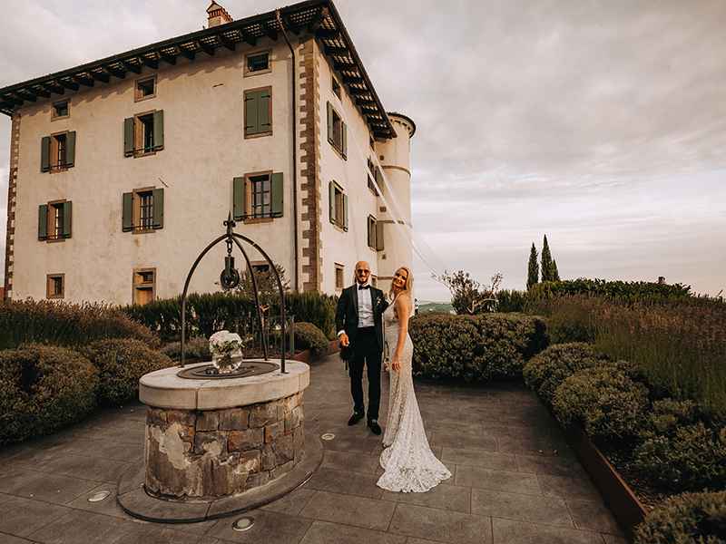 Nevesta v poročni obleki znamke Berta in ženin v obleki Hugo Boss stojita pred vodnjakom hotela Gredič, ki je njuna poročna lokacija. Organizator porok je poskrbel, da je vsak detajl urejen po njunih željah, kot tudi dekoracija na vodnjaku, blago iz hotelskih oken ter cvetje na travi.